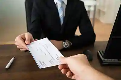 Woman handing a paycheck